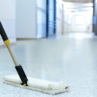 Mop cleans the floor in a Long corridor